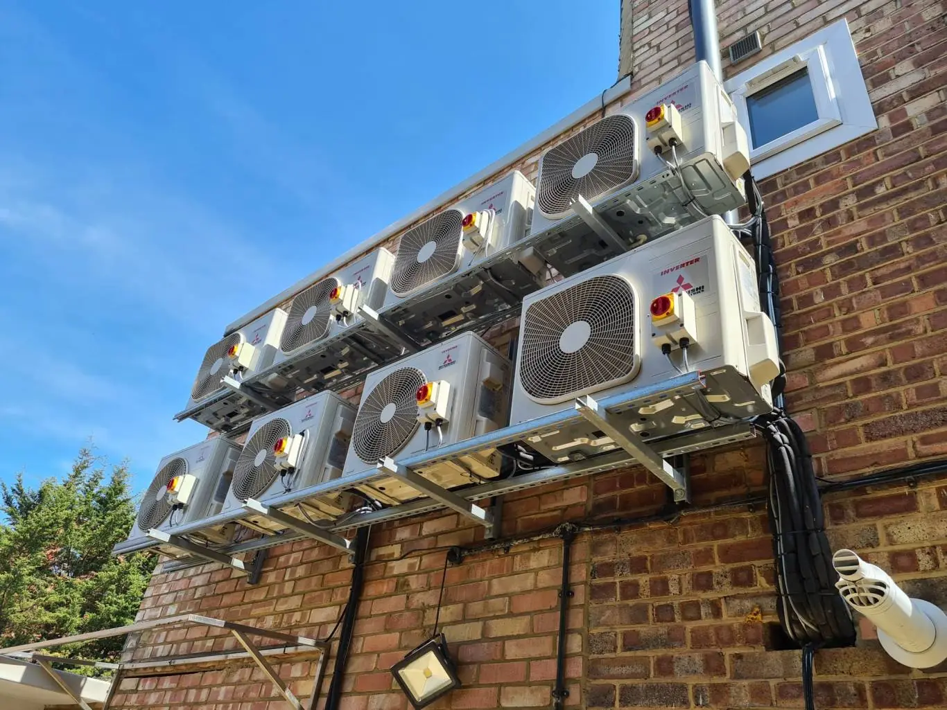 Air conditioning in London: a bank of condenser units installed on a brick wall by RAS Cooling Solutions